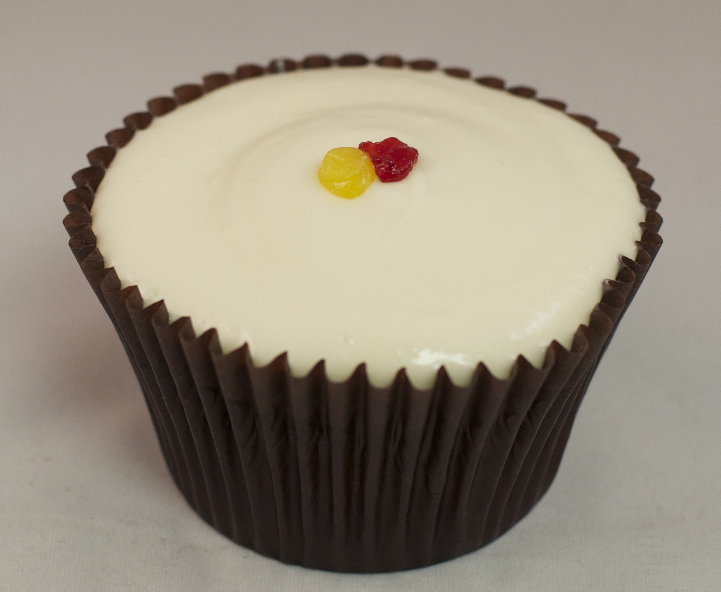 on top yellow red cream with lemon raspberry cupcake