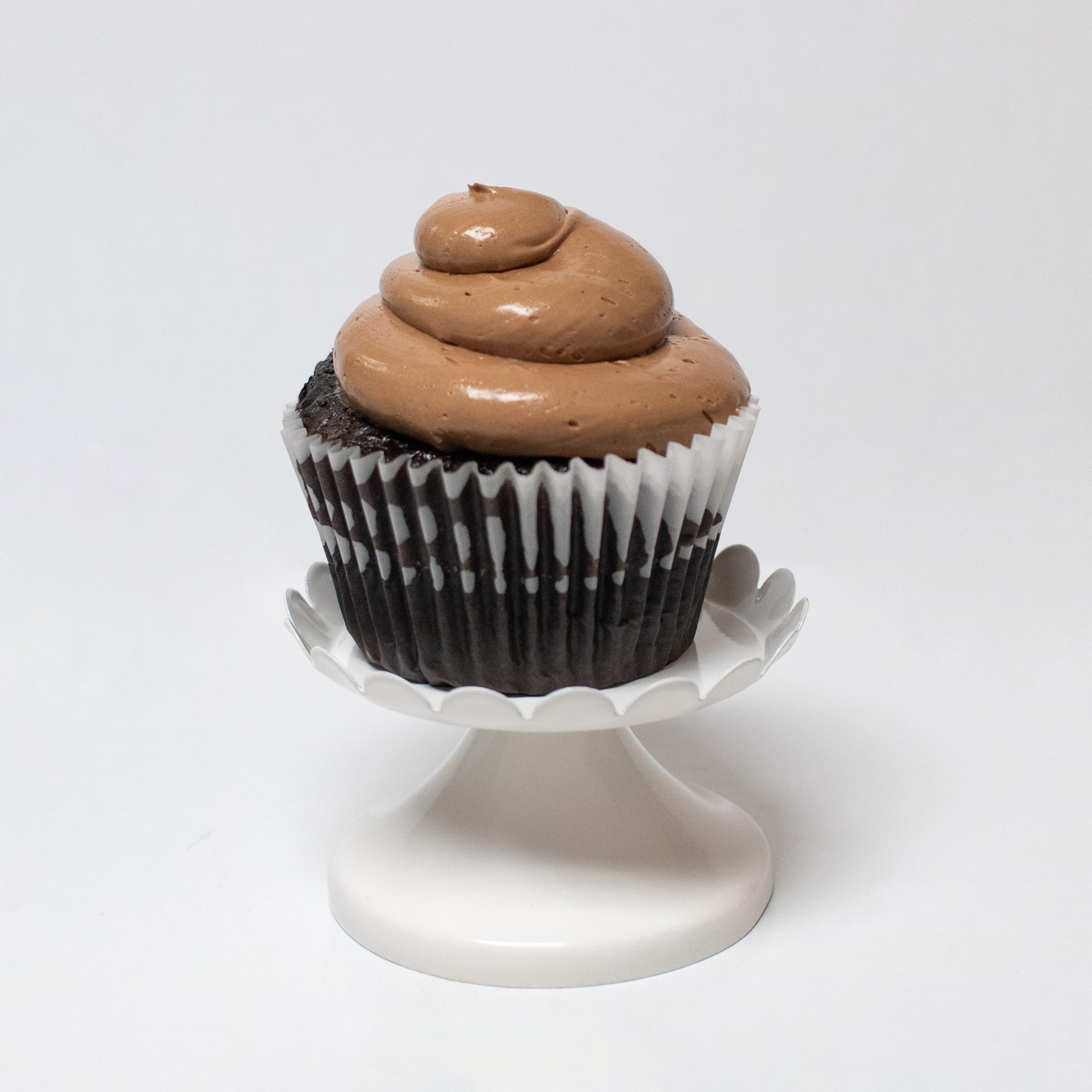 on top brown cream with gluten free chocolate cupcake